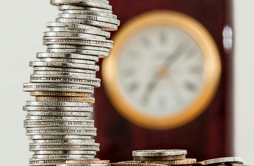 stacks of coins with a clock. Its not too late to start wealth building